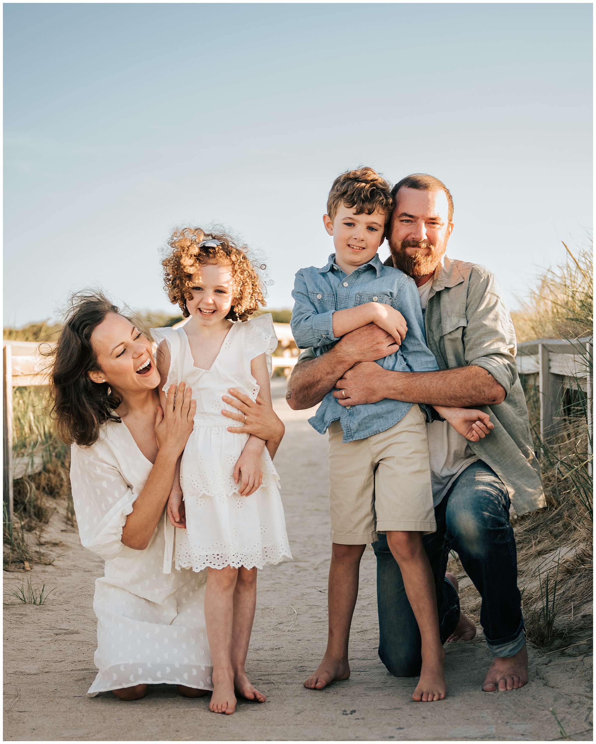 A professional family portrait of a young, smiling family at the beach in Ipswich, Massachusetts.